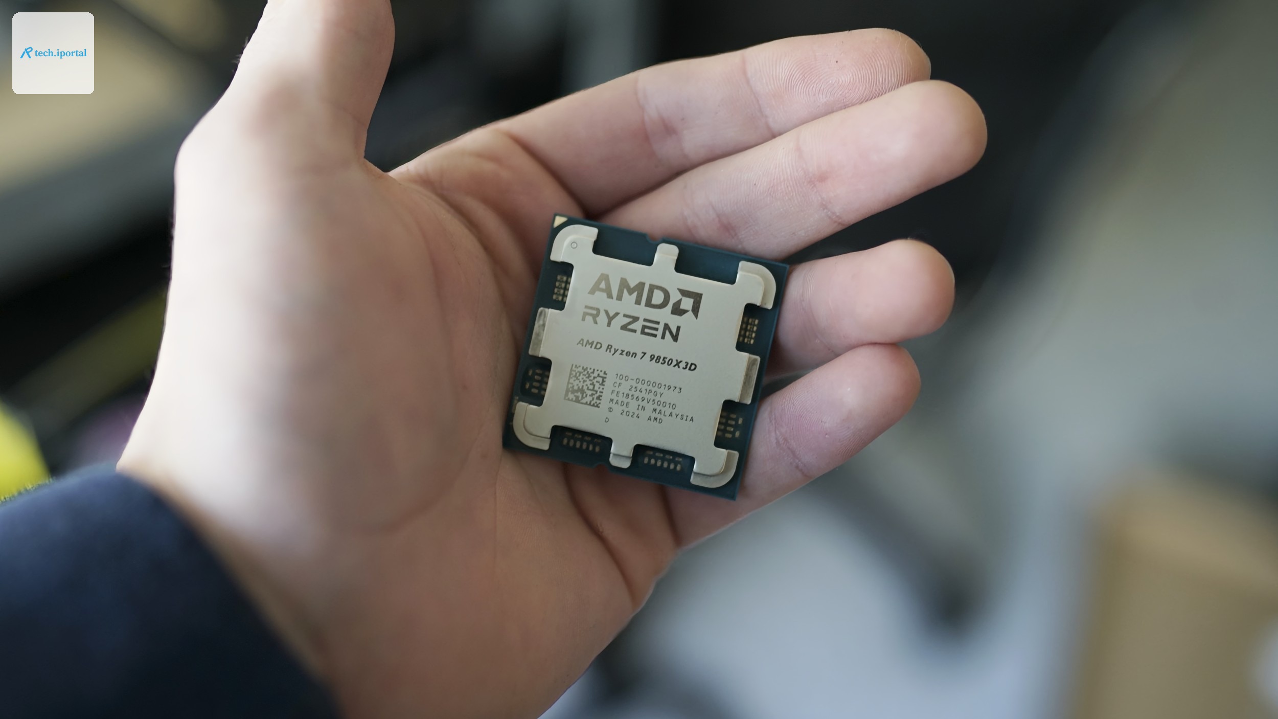 A hand holding the Ryzen 7 9850X3D.