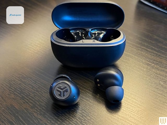 JLab Go Pop ANC, black ear buds in front of an open, black, oval-shaped case