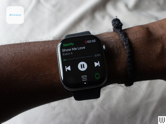 Closeup of a persons wrist wearing a smartwatch with a digital screen showing music mode