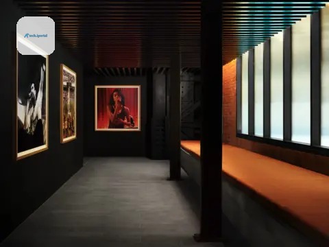 Apple Music A corridor featuring photos of artists including Olivia Dean on the wall