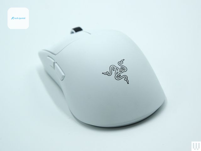 Back of a white computer mouse with a black scrolling wheel two large buttons on top and two small buttons on the left side