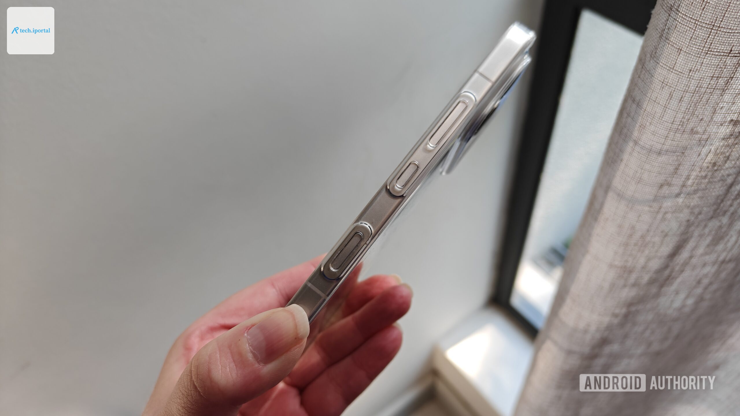 a phone held in a hand showing its side buttons