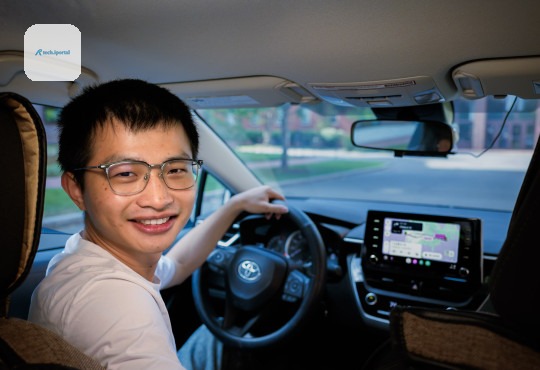 Geophysicist Xiyuan Bao behind the wheel of his car