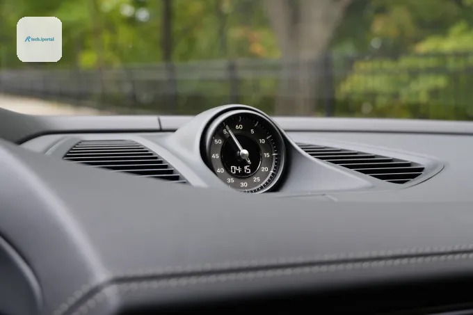 A clock sits atop a dash.