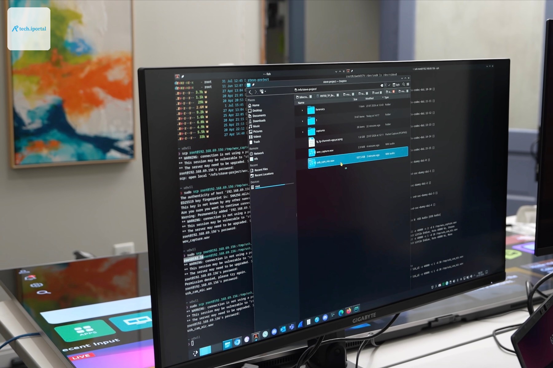 A computer screen showing code with an LG TV lying on the tabel behind it.