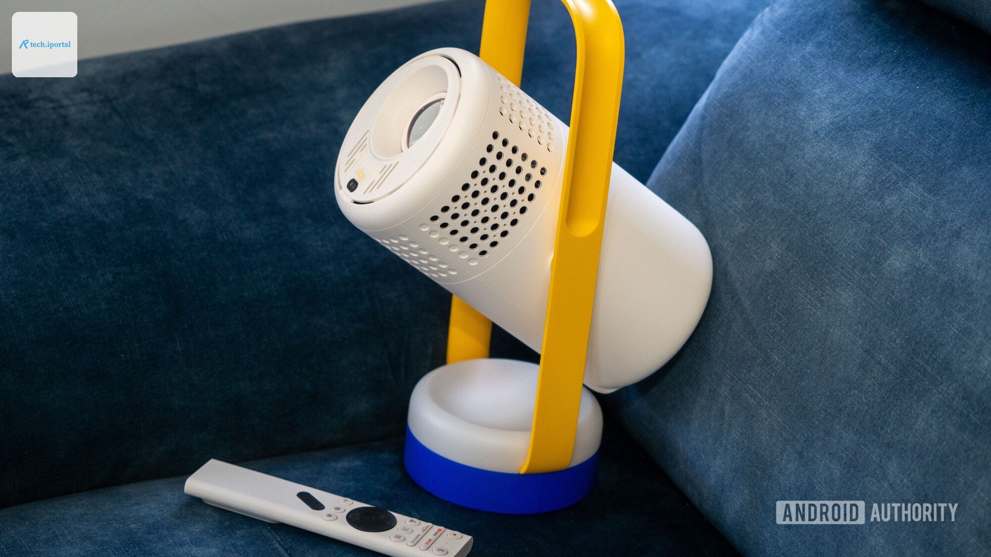 xgimi vibe one projector on sofa with remote