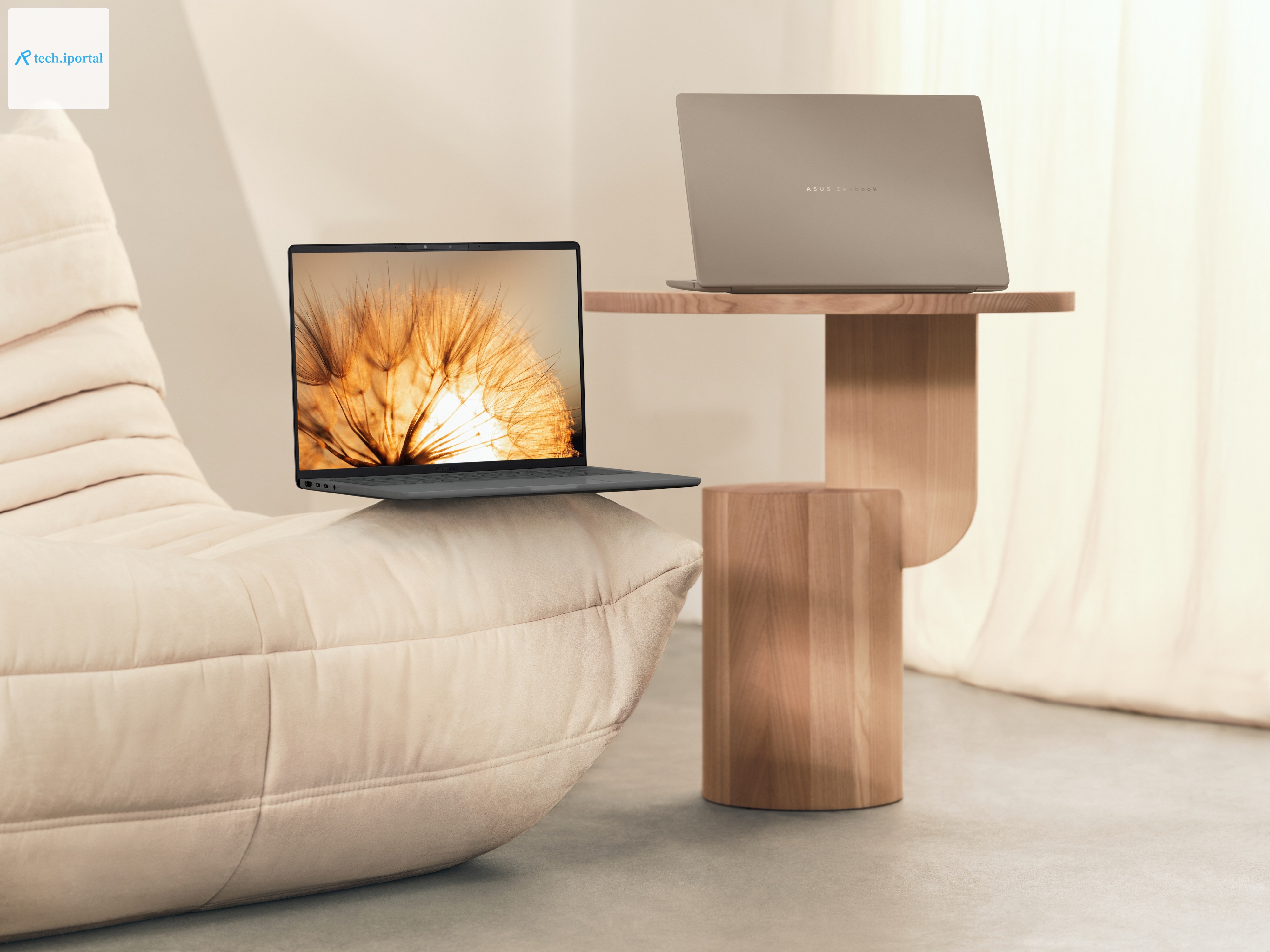 A pair of Asus Zenbook A14 laptops on a couch and end table.