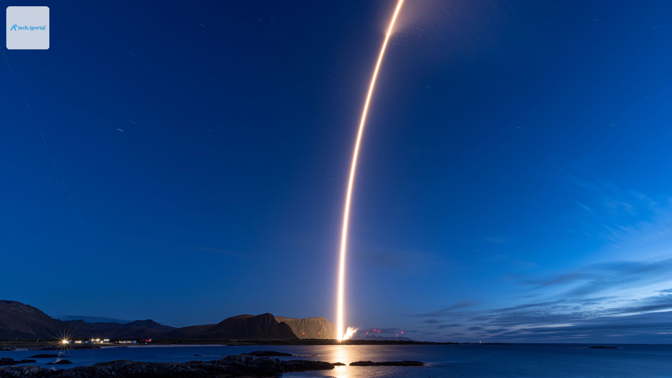 A rocket launch carves an orange arc into a dark night sky in this long-exposure photo.