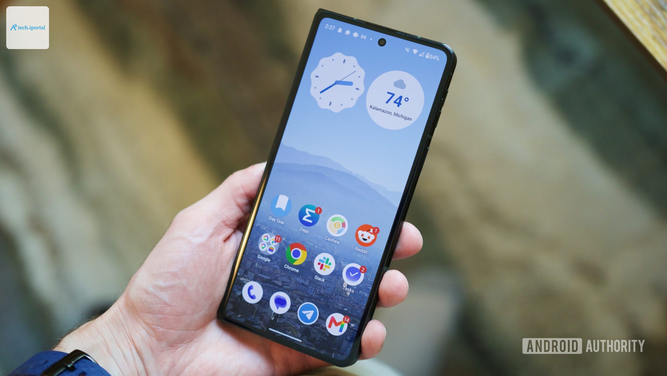 Holding the Motorola Razr Fold with its cover screen on.