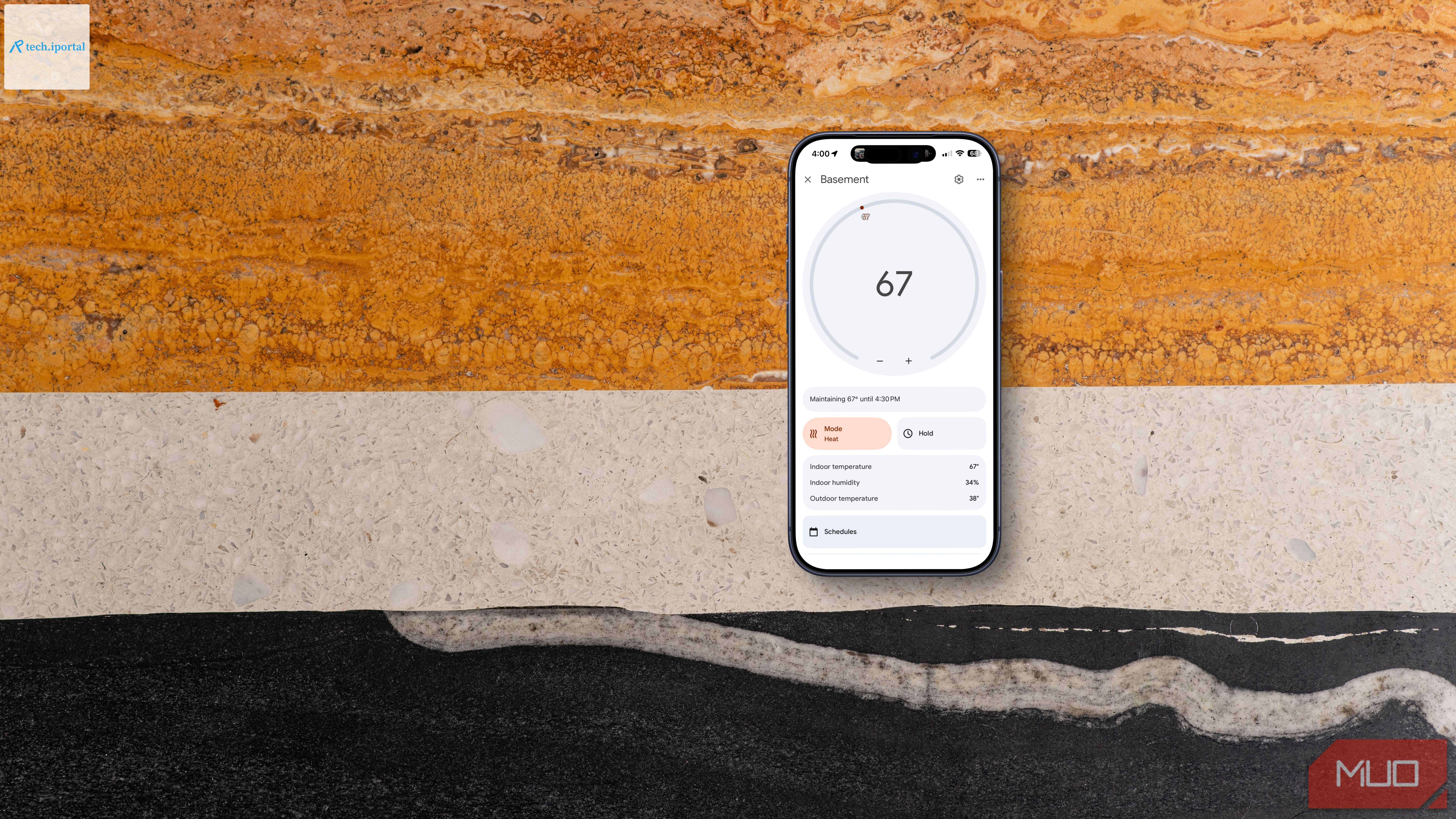An iPhone on a table showing smart thermastat controls.