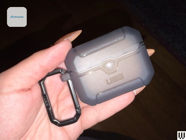 Hand holding a small rectangular case with a keychain attached