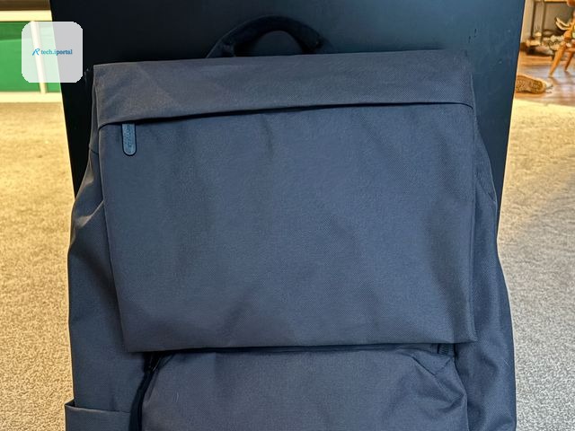 Front view of Everlane ReNew Transit Backpack, a grey bag with black straps and simple zipper pouch