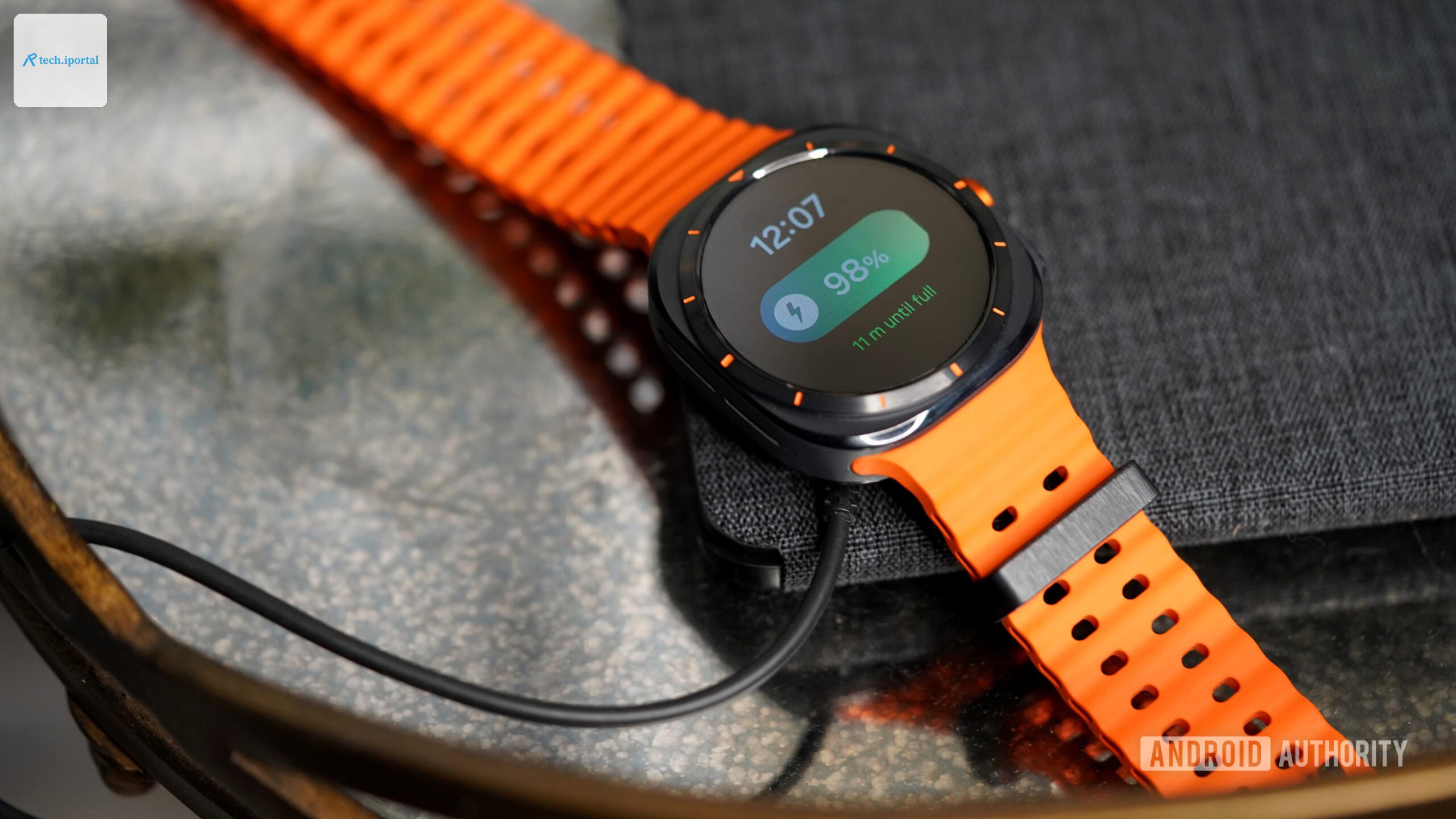 A Galaxy Watch Ultra rests on its charger.