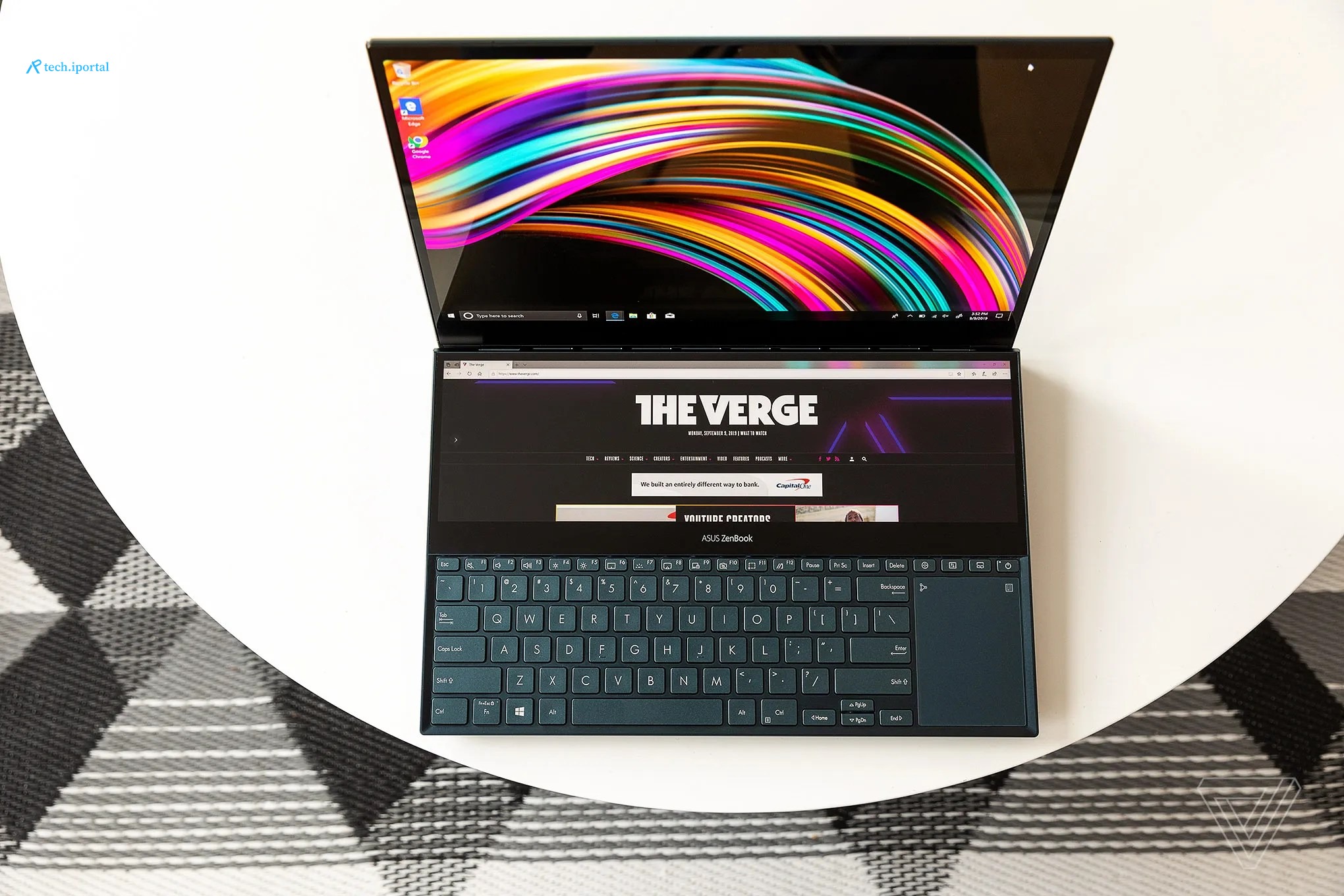 The Asus ZenBook Pro Duo laptop on a white table.