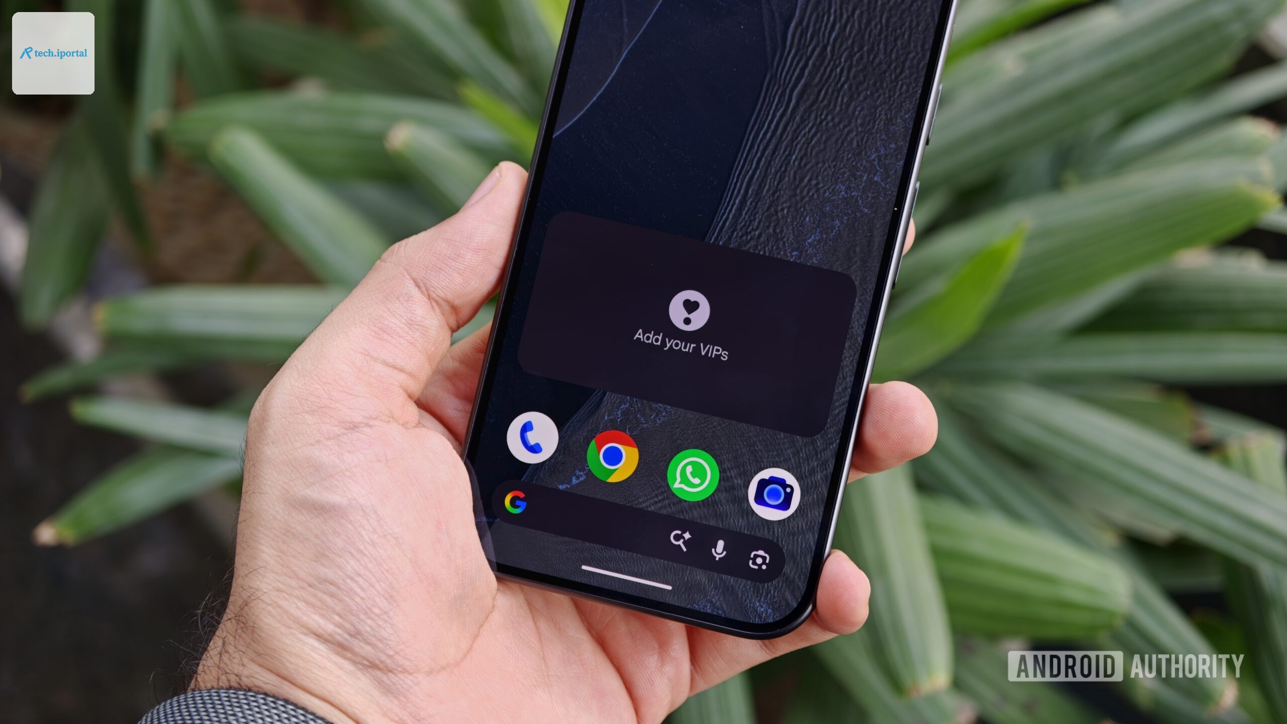 Hand holding an Android smartphone showing an empty "Add your VIPs" widget on the home screen