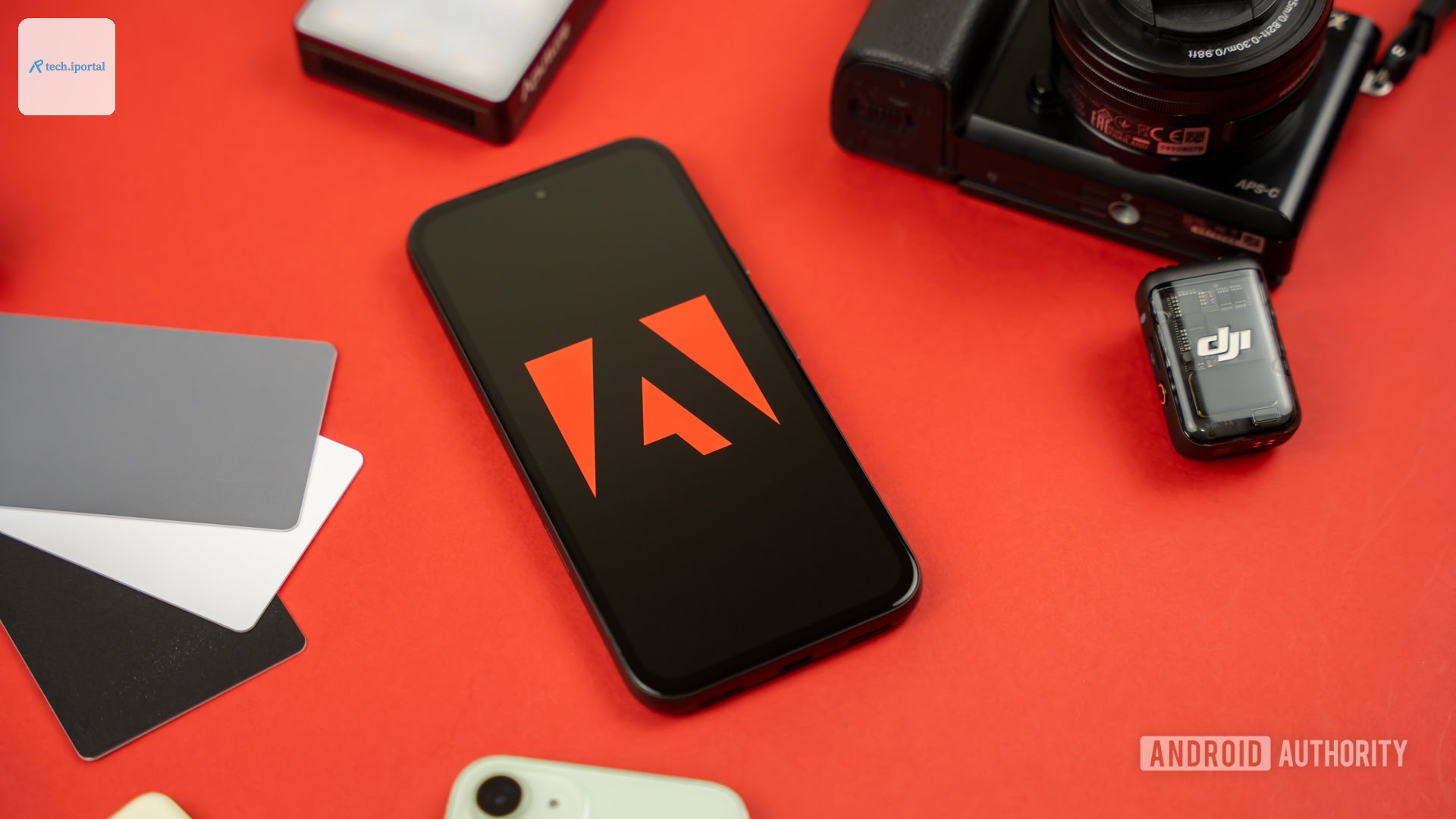 Adobe logo on smartphone, next to photography and videography products stock photo (3)