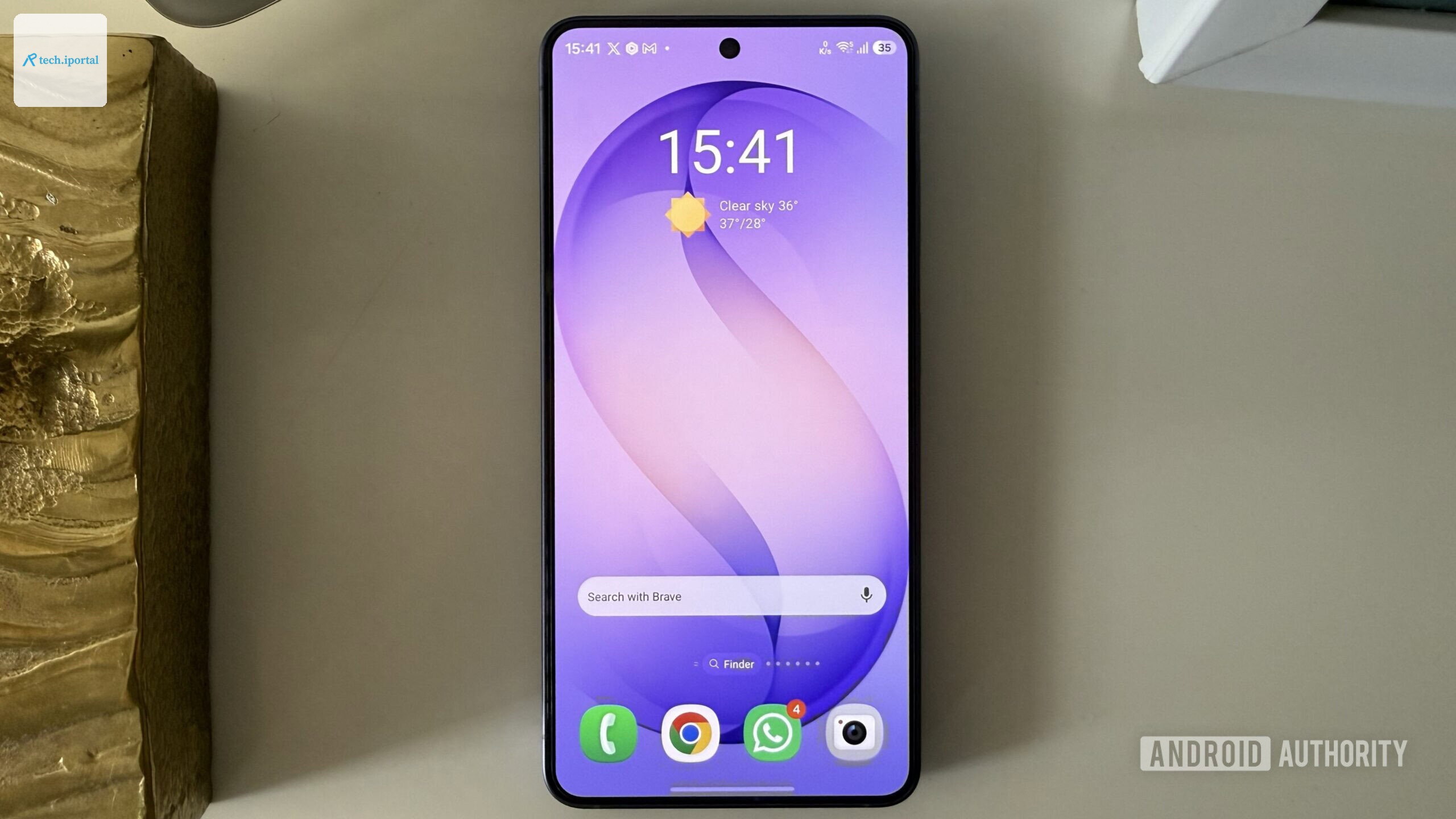 Android phone on a white surface showing home screen widgets