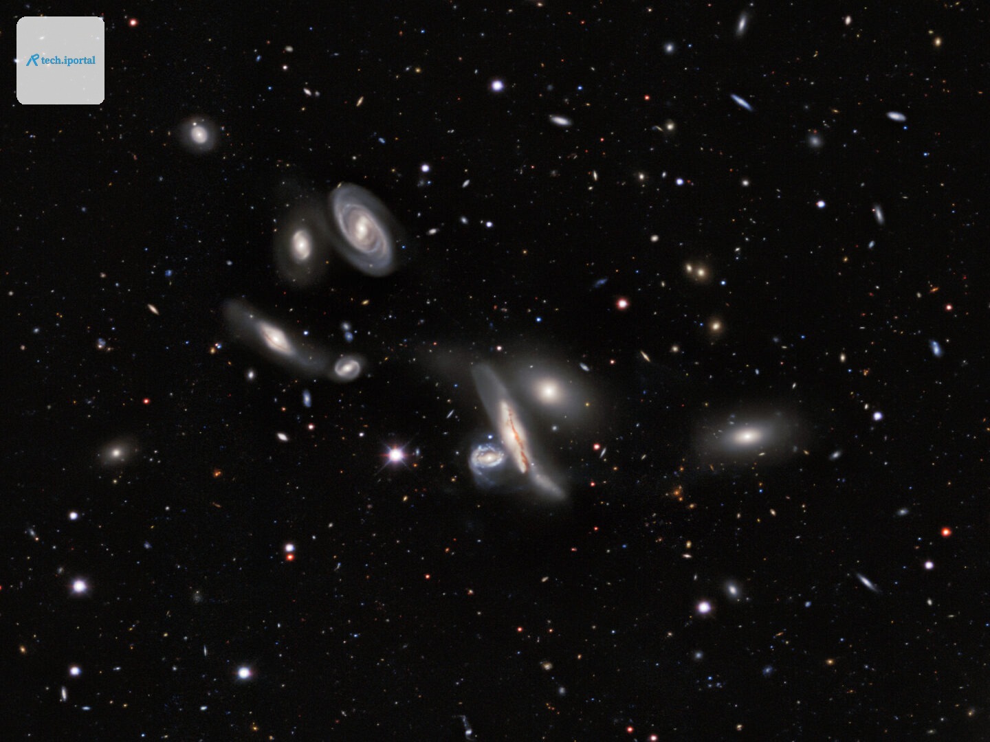 Seven bright galaxies on a black background full of points of light.