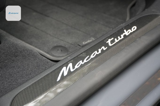 Carbon fiber door sills reflect light from above.