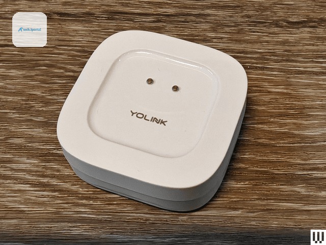 White rounded square device on wooden surface with brand name YoLink