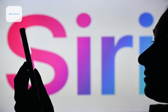 An image of a woman holding a cell phone in front of the Siri logo displayed on a computer screen.