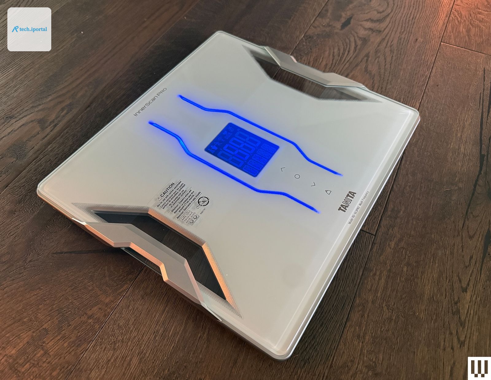 Slim white scale with digital screen on top of a wooden floor
