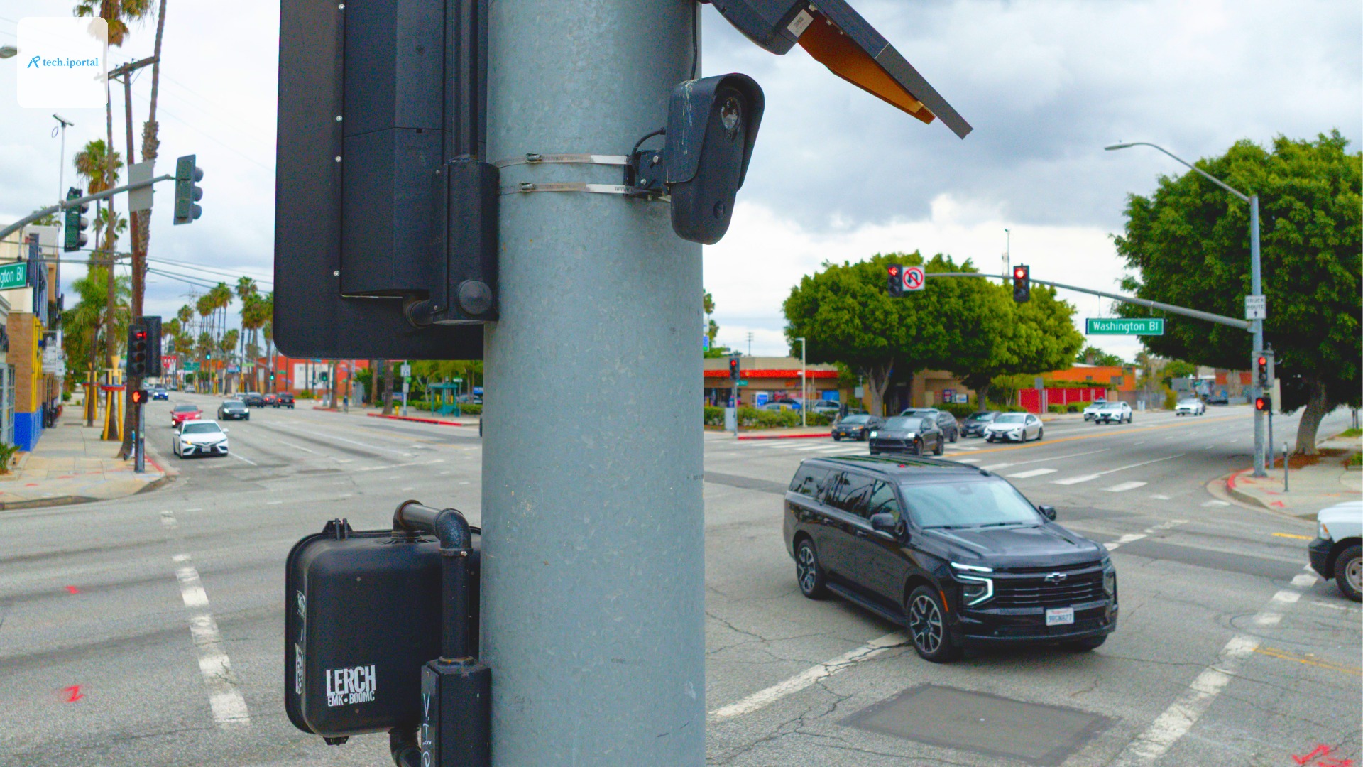 a Flock license plate reader mounted on a stoplight at an intersection